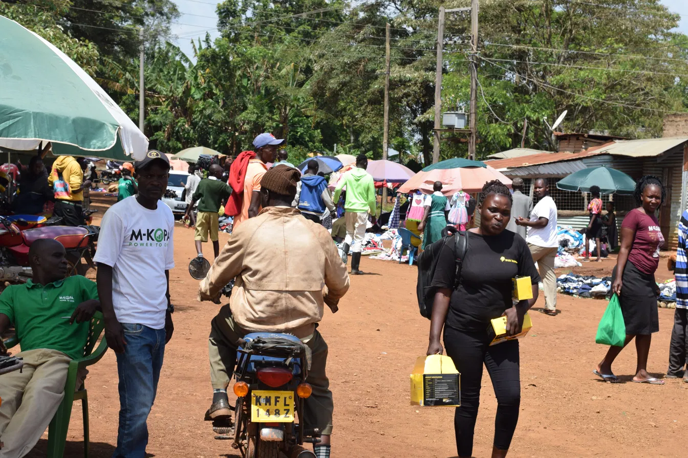 Sun King female activator open air market consumer engagement Kenya CMEM Group